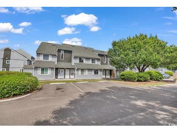 Attractive two-story townhomes feature reserved parking, mature landscaping, and classic architecture at 3700 Golf Colony Lane # 5J, Little River, SC 29566