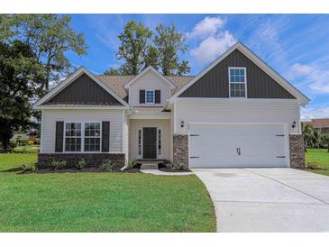 Charming home with a two-car garage, brick accents, neutral siding and a well-manicured lawn at 438 Lifestyle Court, Surfside Beach, SC 29575