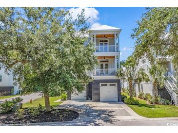 Charming two-story home features a double garage, balconies, and manicured landscaping at 48 Half Shell Ct., Litchfield, SC 29585