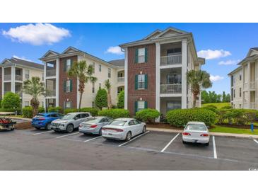 View of exterior and parking for this lovely condo community with lush landscaping at 480 River Oaks Dr. # 63-O, Myrtle Beach, SC 29579
