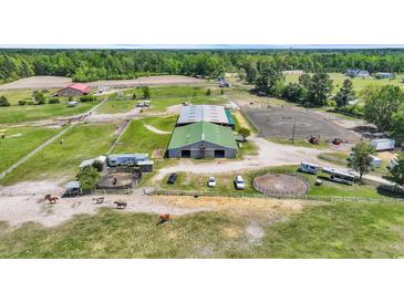 Expansive horse farm with large barns, riding areas, and green pastures for livestock to graze freely at 6200 Adrian Pkwy., Conway, SC 29526