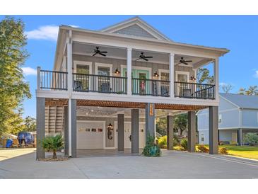 Charming coastal home featuring a double front porch, covered parking, and stylish beachside decor at 355 Oak Ave., Murrells Inlet, SC 29576
