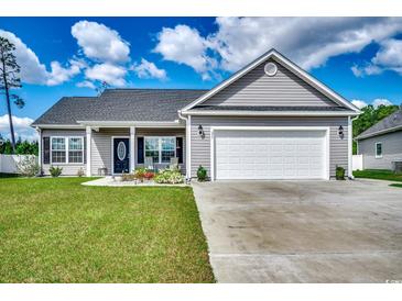 Charming single-story home with a well-manicured lawn, gray siding and white trim, plus an attached two-car garage at 377 Copperwood Loop, Conway, SC 29526