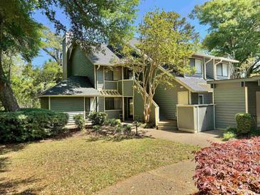 Charming two-story townhouse with manicured landscaping and mature trees, offering a serene setting at 421 Appledore Circle # 5-D, Myrtle Beach, SC 29572