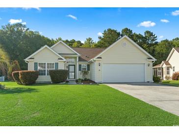 Charming single-story home features a well-manicured lawn, attached garage, and inviting curb appeal at 812 Buteo Ct., Myrtle Beach, SC 29588
