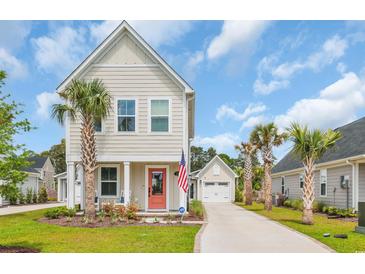 Charming two-story home featuring a delightful coral door, inviting front porch, and well-maintained landscaping at 9012 Mabel Ct., Longs, SC 29568