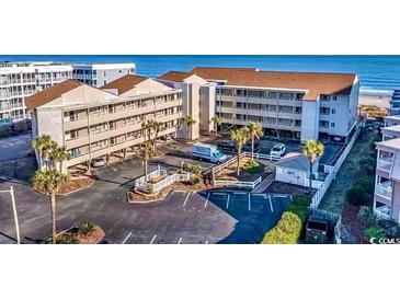 Aerial view of condo community showcasing the building's proximity to the beach, pool, and parking areas at 9570 Shore Dr. # 204, Myrtle Beach, SC 29572