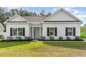 Charming single-story home featuring a manicured lawn, white siding, and black shutters at 1500 Sunmeadow Dr., Conway, SC 29526