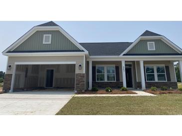 Charming single-story home featuring a two-car garage and stone accents at 962 Oak Hollow St., Longs, SC 29568
