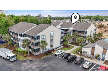 Exterior view of condominium building with landscaping, parking lot and construction area at 250 Maison Dr. # J-11, Myrtle Beach, SC 29572
