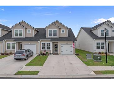 Inviting townhome with a well-manicured lawn and a charming, neutral-toned facade at 291 Brackish Dr. # 291, Myrtle Beach, SC 29588