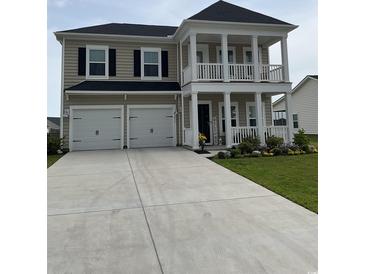 Charming two-story home featuring a spacious front yard, two-car garage, and a double porch at 3019 Visionary Dr., Myrtle Beach, SC 29588