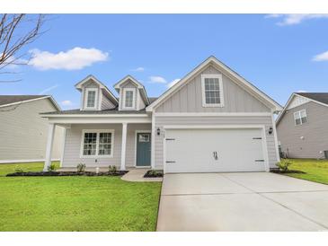 Charming single-Gathering home featuring a two-car garage, well-kept lawn and a welcoming entryway at 3332 Little Bay Dr., Conway, SC 29526
