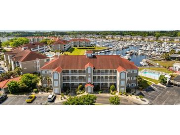 Stunning aerial view of complex with marina, multiple pools and well maintained landscaping at 4200 Coquina Harbour Dr. # H5, Little River, SC 29566