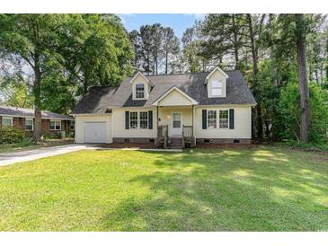 Charming home with a well-manicured lawn and dormer windows at 505 Forestbrook Dr., Myrtle Beach, SC 29579