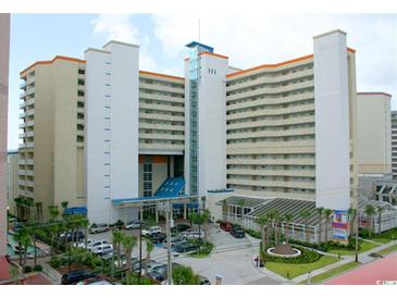 Expansive exterior view of a hotel featuring multiple floors and balconies, with palm trees and parking area at 5300 N Ocean Blvd. # 310, Myrtle Beach, SC 29577