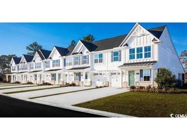 Charming new construction townhomes featuring modern architecture and a welcoming street presence at 532 Ryegrass Way # 0029B, Murrells Inlet, SC 29576