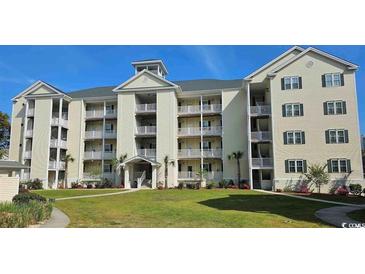 Beautiful condominium featuring balconies, lush landscaping, and a charming building design at 601 Hillside Dr. N # 1405, North Myrtle Beach, SC 29582