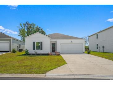 Charming single-story home with a well-maintained lawn and attached two-car garage at 109 River Vista Way, Myrtle Beach, SC 29588