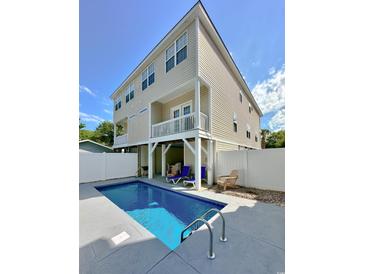 Relaxing pool with fenced-in backyard provides privacy, a perfect outdoor space for entertaining and lounging at 118A 6Th Ave. N, Surfside Beach, SC 29575