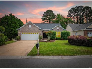 Charming brick home with a well-manicured lawn and mature trees, perfect for curb appeal at 1504 Sedgefield Dr., Murrells Inlet, SC 29576