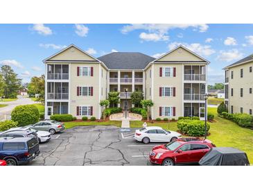 Beautiful multi-level condo with screened in porches, manicured landscaping and convenient parking at 2090 Cross Gate Blvd. # 202, Surfside Beach, SC 29575