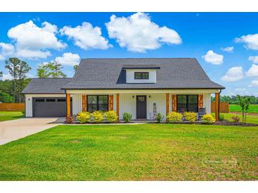Charming, single story home with a well-manicured lawn and beautiful landscaping at 3117 Chapel Rd., Loris, SC 29569