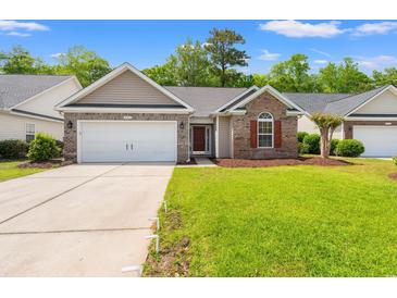 Charming single-story home with brick accents, manicured lawn, and a two-car garage at 4165 Eva Bay Dr., Murrells Inlet, SC 29576