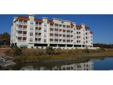 Spacious condo building with private balconies, parking garage, and beautiful pond view at 502 48Th Ave. S # 402, North Myrtle Beach, SC 29582