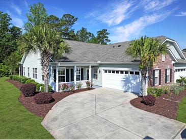 Charming home features a well-manicured yard with a concrete driveway and an attached two-car garage at 1250 Camlet Ln., Little River, SC 29566