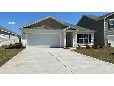 Charming single-story home with a white facade, attached garage, and well-maintained landscaping at 152 Ashworth Dr., Tabor City, NC 28463