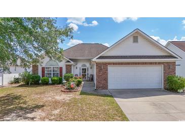 Charming single-story home with well-manicured lawn, brick accents, and attached two-car garage at 162 Jessica Lakes Dr., Conway, SC 29526