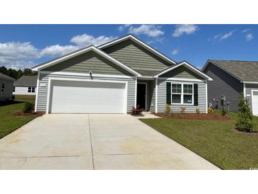 Charming single-Gathering home with a two-car garage, neat landscaping and a mix of horizontal and gabled siding at 177 Ashworth Dr., Tabor City, NC 28463