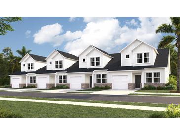 Charming new construction townhomes featuring white siding, brick accents, and attached garages, located in a desirable community at 2004 Wild Indigo Circle Nw # 111, Calabash, NC 28467