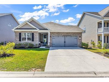 Charming single-story home with a well-manicured lawn and a convenient two-car garage at 305 Calhoun Falls Dr., Myrtle Beach, SC 29579