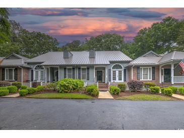 Charming townhome with well-manicured landscaping, a welcoming front porch, and an inviting curb appeal at 307 Golden Bear Dr. # 3, Pawleys Island, SC 29585