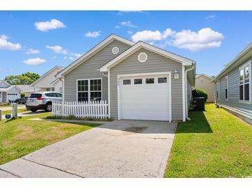Charming single-story home boasts a well-manicured lawn and attached one car garage at 408 Chesterfield Ct., Myrtle Beach, SC 29577