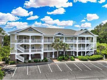 Three-story condo building with ample parking and well-maintained landscaping at 6203 Catalina Dr. # 1832, North Myrtle Beach, SC 29582