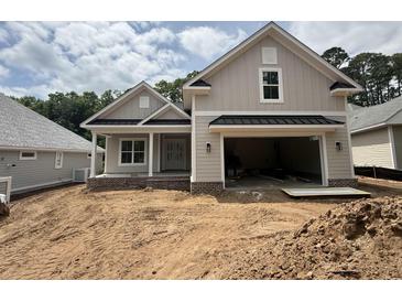 Charming single-Gathering home showcasing an attached garage, and a neutral color palette at 924 Morrall Dr., North Myrtle Beach, SC 29582