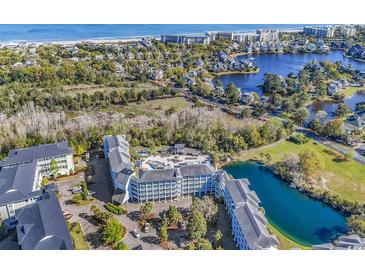 Stunning aerial view of the community showcases its proximity to the beach, a pond, and manicured landscapes at 14290 Ocean Hwy. # 210, Pawleys Island, SC 29585