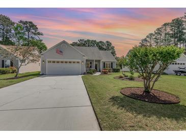 Charming single-story home featuring an attached two-car garage, mature landscaping, and inviting curb appeal at 1486 Medinah Ln., Murrells Inlet, SC 29576