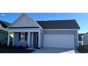 Charming single-story home features a two-car garage and a cozy front porch, perfect for relaxation at 2884 Riverboat Way, Conway, SC 29526