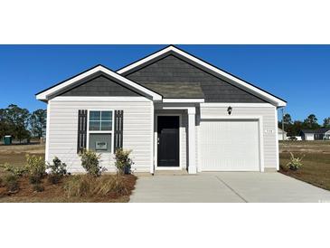 Charming single-story home featuring a one-car garage, black door, and complementary white and gray siding at 296 Clear Lake Dr., Conway, SC 29526