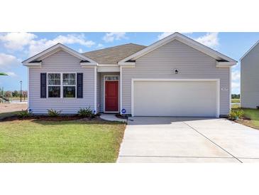 Charming single-Gathering home featuring a red front door, light gray siding, well-manicured lawn, and a two-car garage at 304 Clear Lake Dr., Conway, SC 29526