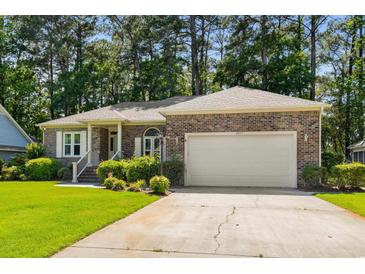 Charming brick home with well-manicured lawn and two-car garage in a desirable neighborhood at 3157 Hermitage Dr., Little River, SC 29566