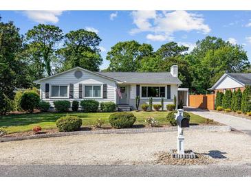 Charming single-story home featuring a well-manicured lawn and attractive landscaping with a gravel driveway at 709 Yucca Ave., Myrtle Beach, SC 29577