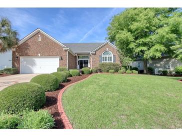 Charming brick home featuring manicured landscaping, healthy green lawn and mature trees at 78 Saltwind Loop, Murrells Inlet, SC 29576