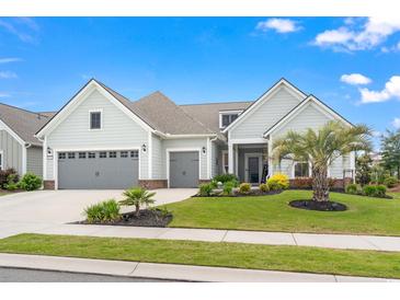 Charming home boasts a manicured lawn, landscaping, a two-car garage, and inviting curb appeal at 1211 Arezzo Ave., Myrtle Beach, SC 29572