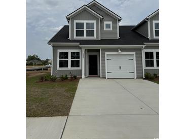 Charming home featuring gray siding, black roof, and a one-car attached garage at 1307 American Shad Dr. # 47, Conway, SC 29526