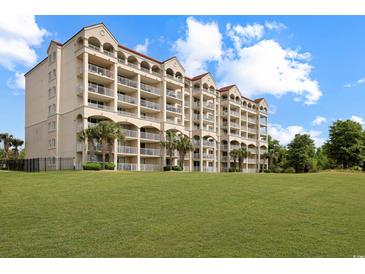Beautiful multi-story building with arched balconies overlooking a pristine green lawn at 2151 Bridgeview Ct. # 3-405, North Myrtle Beach, SC 29582